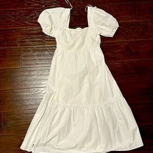 White ASTR dress with slit on the right.